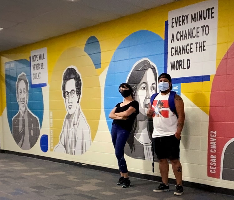 Diana Aguilar and Teo Pantoja posing in front of completed Diversity Mural